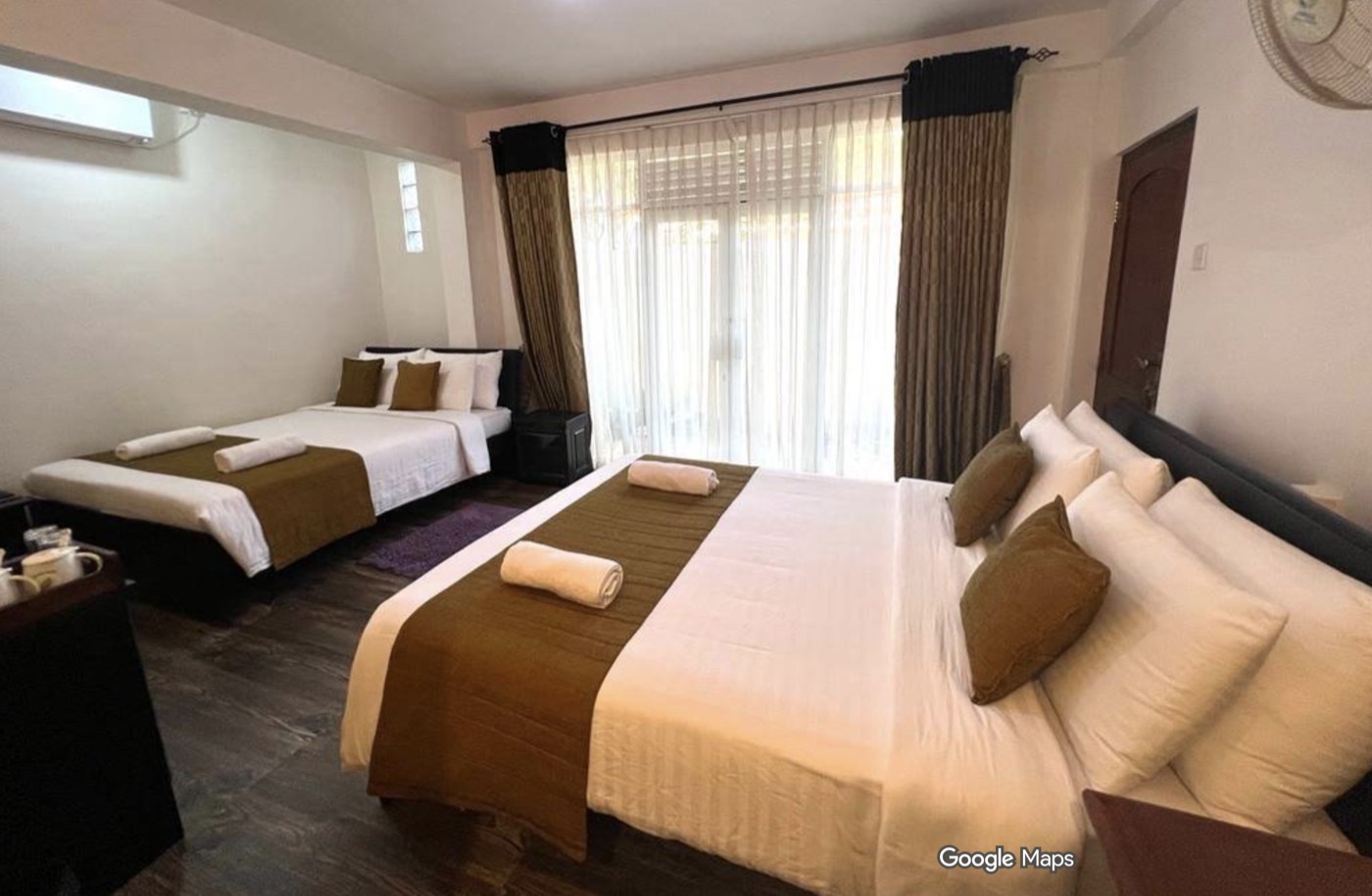 Deluxe Triple room at Ella Moon Rock, with two beds made up for guests